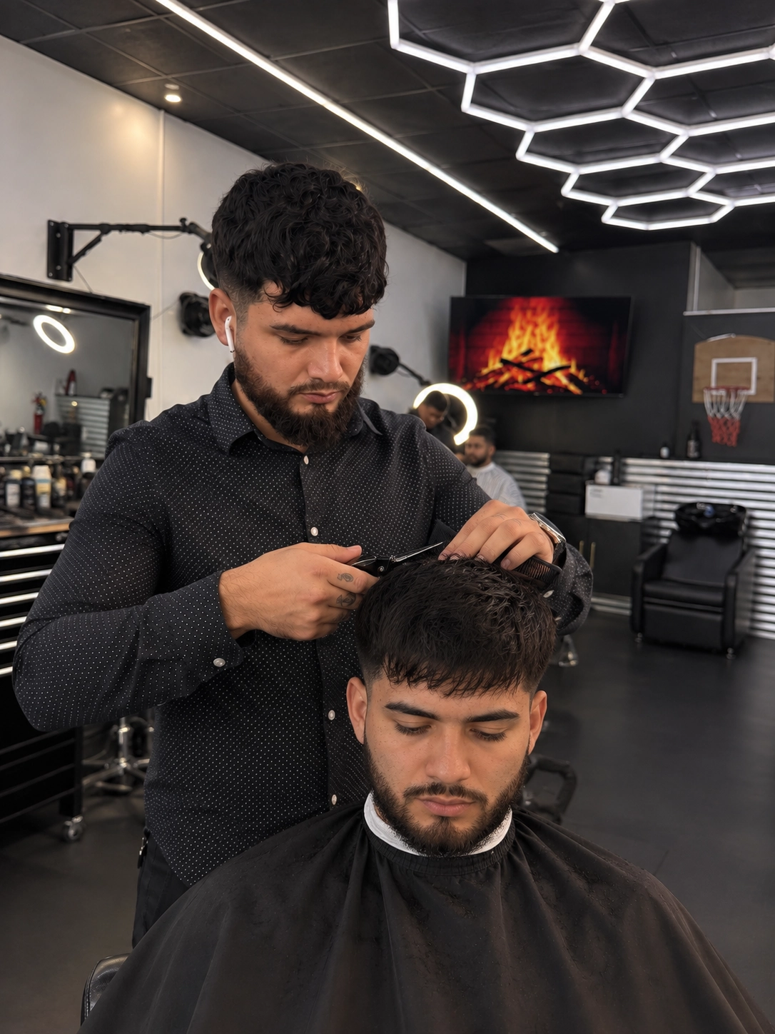 Refugio barber cutting a client’s hair with scissors and a comb