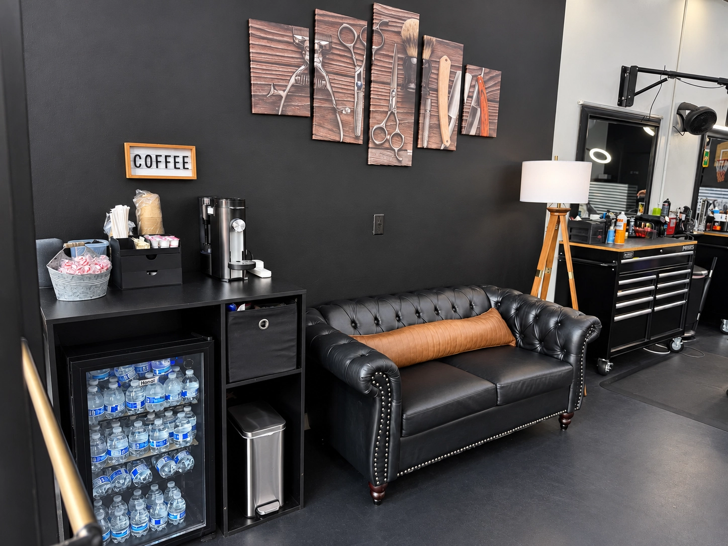 Refugio’s lounge: a leather Chesterfield sofa, a coffee station and barber-tool artwork